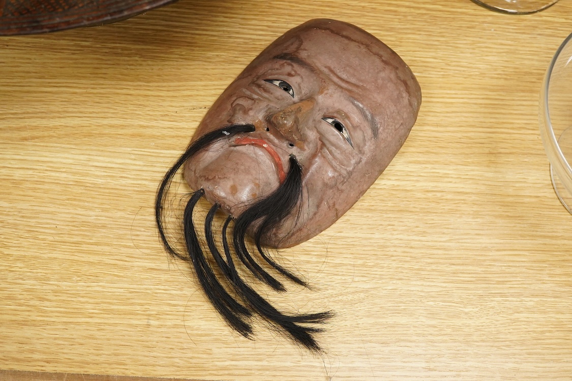 A wooden bowl with a decorative carved rim - 44cm wide across rim and an oriental carved and painted wooden face mask